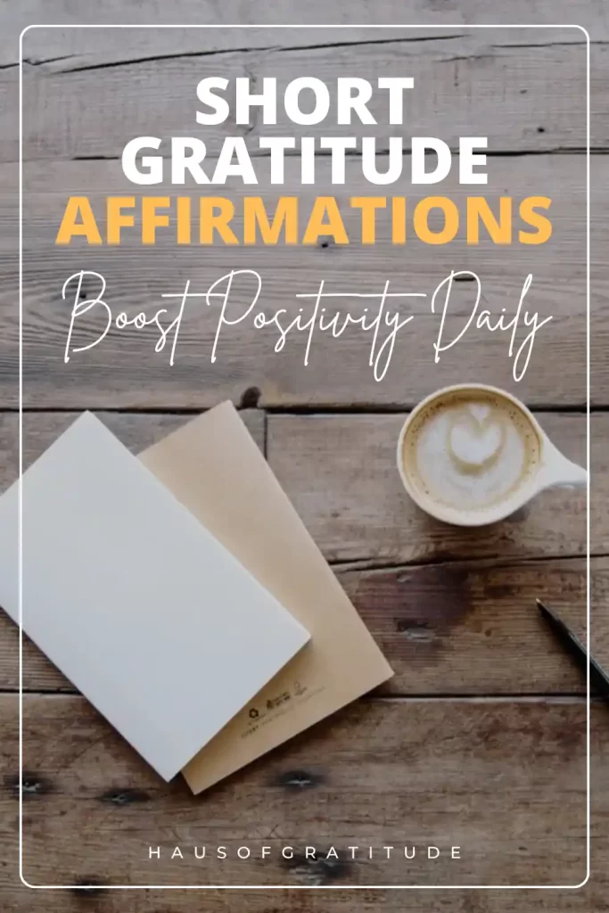 A wooden table featuring a blank notebook, a cup of coffee with a heart-shaped design in the froth, and a pen. Text overlay states "Short Gratitude Affirmations: Boost Positivity Daily".