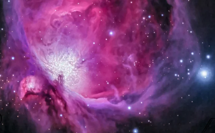 Cosmic nebula with swirling pink and purple hues, representing universal energy.